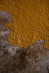 Abstract painted of rotten wall in orange or mustard color