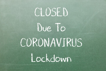 Closed Due To Coronavirus Lockdown Inscription on dark board with chalk. Impact of coronavirus on business.