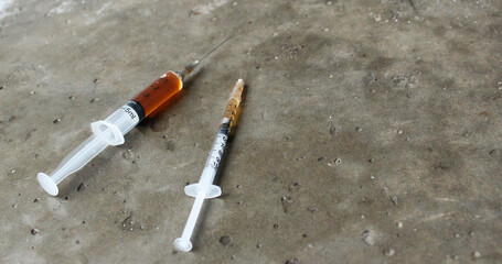 Concrete background with syringes with drug