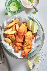 Hot fish and chips served with lime and salt