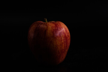 fresh red apple with against black background with space for text