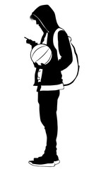 Silhouette of a young man with a ball and a cell phone