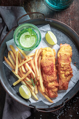 Tasty fish and chips served with lime and salt