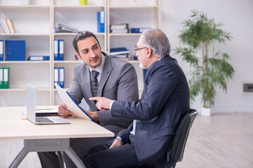 Old and young businessmen in business meeting concept