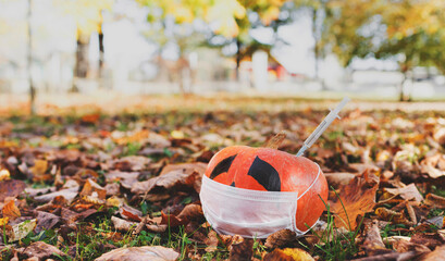 sick pumpkin covid19 in a mask.Injection syringe vaccination