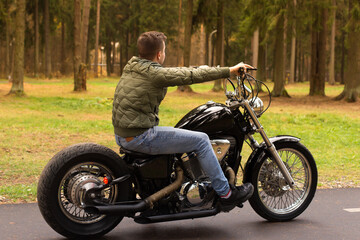 Fototapeta na wymiar Young man on a motorcycle, Road