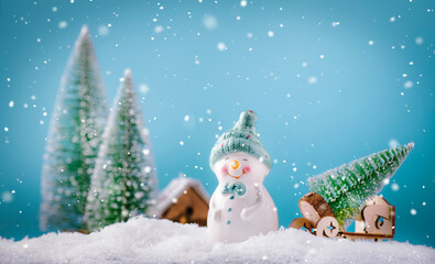 Merry Christmas and happy New Year composition with copy space. Little snowman carries Christmas...