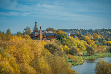 Autumn landscape with church and river in Moscow Region, Russia