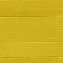 A yellow vintage rough sheet of carton. Recycled environmentally friendly cardboard paper texture. Simple and bright minimalist papercraft background.