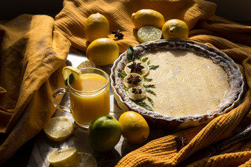 Lemon tart on grey tiled kitchen table.  Homemade dessert top view photo. 
