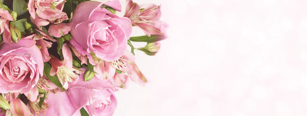 Fototapeta na wymiar Beautiful pink rose and alstroemeria flowers in a bouquet on soft bokeh