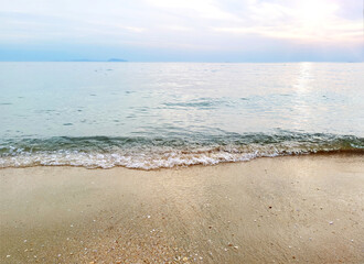 Soft sea waves on sandy beach background