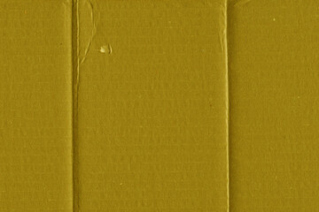 A yellow vintage rough sheet of carton. Recycled environmentally friendly cardboard paper texture. Simple and bright minimalist papercraft background.
