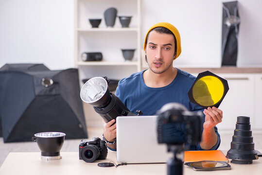 Young male photographer recording video for his blog