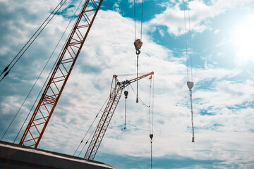 Construction crane against the sky - 389369240