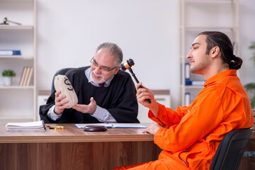 Old male judge meeting with young captive in courthouse