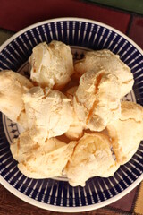 Breakfast, with starch biscuit, cheese bread, served on a wooden table outdoors. Farm breakfast. Coffee, coffee strainer on the table.
