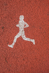 Runner sign on a sports track in the park. White and red. Vertical image.