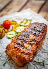 grilled meat ribs with vegetables on wooden table