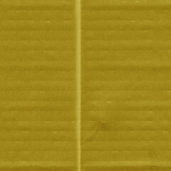 Obraz premium A yellow vintage rough sheet of carton. Recycled environmentally friendly cardboard paper texture. Simple and bright minimalist papercraft background.