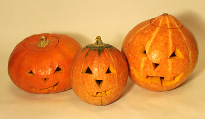 Pumpkins with carved faces on a white background