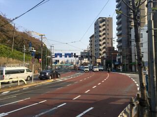 Fototapeta na wymiar TOKYO, JAPAN - APRIL 3, 2018: Japanese cars are driving along a city road. Passenger cars go to the green light in one stream.