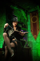 Fototapeta na wymiar women in a hat in the witch's room on Halloween