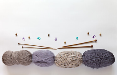 Accessories and materials for hand knitting. Wooden knitting needles and different types of woolen...