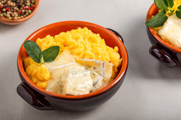 Dish of polenta with melted gorgonzola cheese