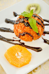 Plate Of Icecream Ball Decorated With An Orange Slice