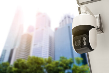 Modern public CCTV camera on wall with blur building background. Recording cameras for monitoring all day and night. Concept of surveillance and monitoring with copy space.