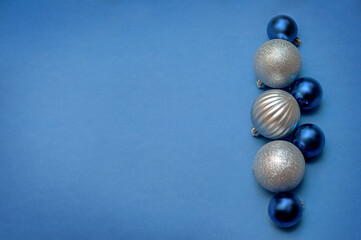 Silver and blue Christmas balls on a blue background