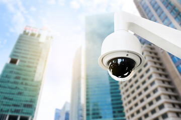 Modern public CCTV camera on wall with blur building background. Recording cameras for monitoring...