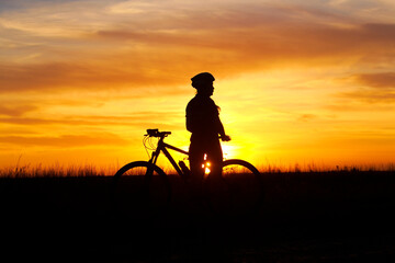 Fototapeta na wymiar silhouette of a person with a bicycle