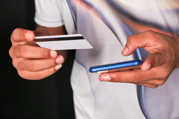 Man hand holding credit card and using smart phone shopping online 