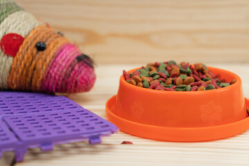 Pets food with toy and plastic floor mat