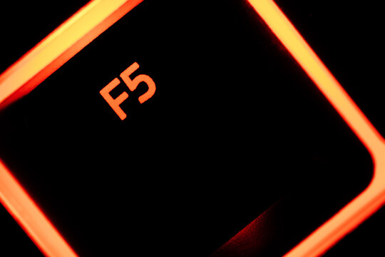 Red illuminated keyboard F5 key closeup