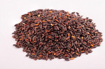 Black wild rice isolated on white background close up.