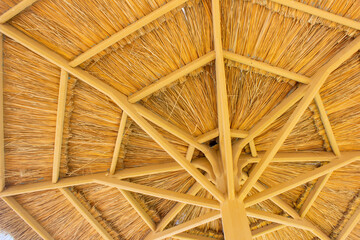 Beach umbrella made of straw and wood
