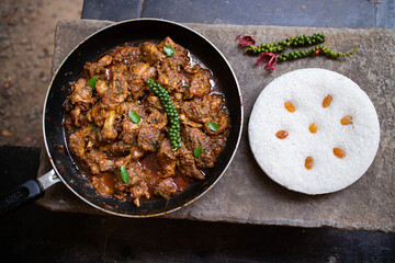 Duck roast Kerala style with Vattayappam steamed Rice cake , homemade chicken curry with Indian spices ,  Asian cuisine spicy meat curry cooked in coconut milk . side dish christian food Christmas