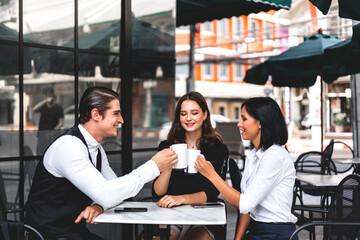 Group of cheerful young friend discussing meeting and talk enjoying their time drinking coffee together.Mixed race people sitting at cafe table and restaurant