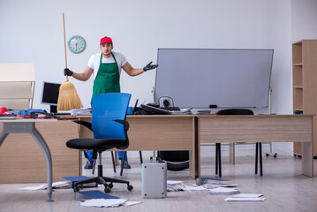 Young male contractor cleaning the office