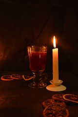 Group of burning candles and mulled wine