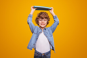 Cute boy with curly hair in studio