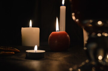 Group of burning candles and mulled wine
