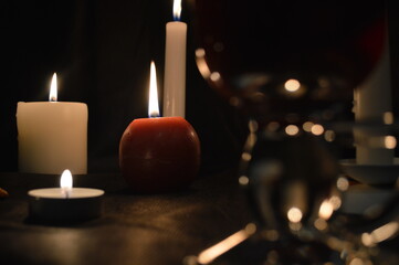 Group of burning candles and mulled wine