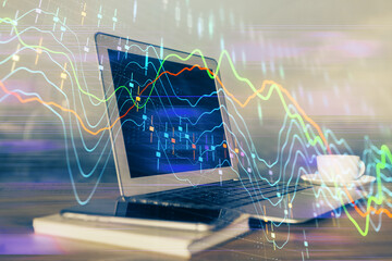 Financial market graph hologram and personal computer on background. Double exposure. Concept of forex.