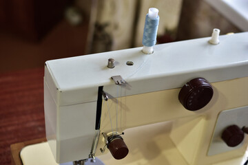 Sewing machine and work surface with needle and thread