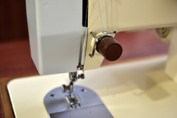 Sewing machine and work surface with needle and thread