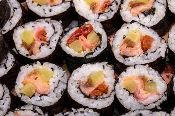 Top view of stack of Japanese sushi maki roll plate. Served in Japanese bar restaurant with chopstick